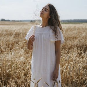 Woman in White Dress Standing on Brown Grass Field
